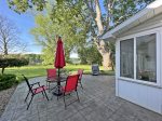 Just off the sun room is the stamped concrete patio with a grill and outdoor dining space complete with views of Lake Allegan